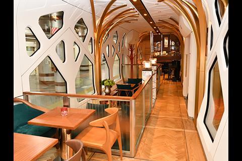 Passengers board the champagne-liveried Train Suite Shiki-Shima via the lounge car where the windows are designed to resemble trees in a forest  (Photo: Akihiro Nakamura).